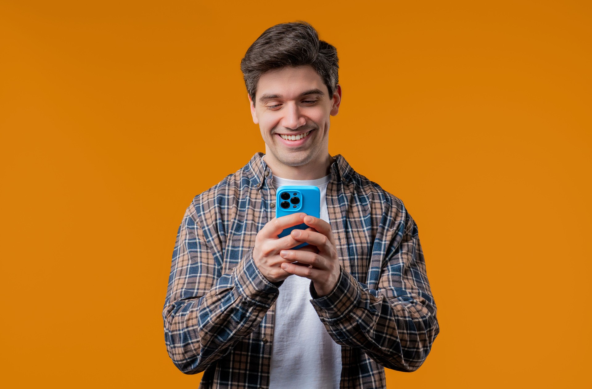 Handsome man surfing internet on smartphone. Guy using social networks, chatting